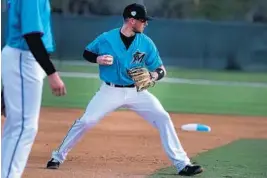  ?? CARLINE JEAN/SUN SENTINEL ?? Marlins shortstop J.T. Riddle gets ready to throw to first during spring training in Jupiter.