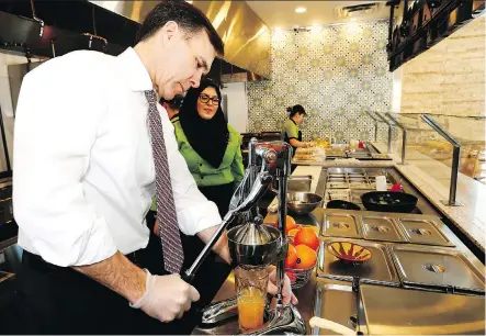  ?? DARREN MAKOWICHUK ?? Finance Minister Bill Morneau visits The Desert Pita and Grill during his visit to Calgary on Wednesday.