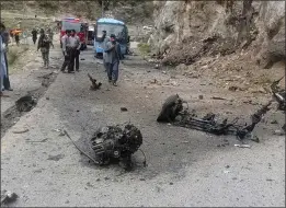  ?? AP PHOTO ?? Police officers examine the site of a suicide bombing at a highway in Shangla district in the Pakistan's Khyber Pakhtunkhw­a province on Tuesday.