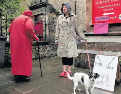  ??  ?? SOLDIERING ON Voters braved the rotten weather at St James’ church in the capital