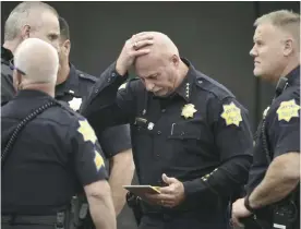  ??  ?? FRESNO: Fresno Police chief Jerry Dyer reviews notes on the triple fatal shooting before addressing the media. — AP