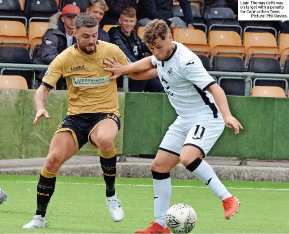  ?? ?? Liam Thomas (left) was on target with a penalty for Carmarthen Town.
Picture: Phil Davies.