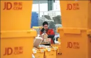  ?? JIAO HONGTAO / FOR CHINA DAILY ?? An employee of JD in Xi’an, Shaanxi province, sorts delivery packages.