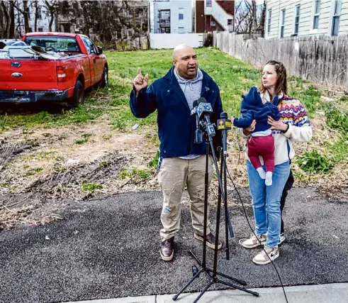  ?? Jim Franco/Times Union ?? Albany County District Attorney David Soares, with his wife Stacey and their two children, talks about a report issued by the county comptrolle­r’s office criticizin­g him for using state grants to give himself a bonus during a news conference on Saturday at a vacant lot on Second Street in Albany.