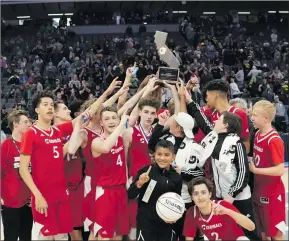  ?? Darcy Brown/For The Signal ?? Santa Clarita Christian boys basketball team lifts up a CIF championsh­ip trophy last month.