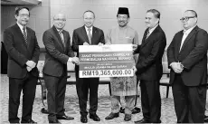  ??  ?? Chief Minister Datuk Seri Musa Aman (third from right) witnessing the handing over the RM19,365,600 zakat from Permodalan Nasional Berhad (PNB) to the Sabah State Government which was handed over by its chairman,Tan Sri Abdul Wahid Omar (third from...