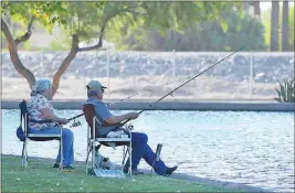  ?? SUN ?? BETTY (LEFT) AND JESS FLORES spend a morning fishing in the pond at West Wetlands Park.