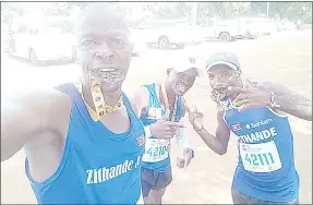  ?? (Courtesy pics) ?? (L-R) Zithande Athletics Club runners Nsizwa Thwala, Themba Vilakati and Maxwell Nzima celebrate with their medals after conquering the race in South Africa.