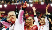  ?? — AFP photo ?? In this file photo taken on July 31, 2012, US women gymnastics team’s coach John Geddert (left) celebrates with the rest of the team after the US won gold in the women’s team artistic gymnastics event at the London Olympic Games.