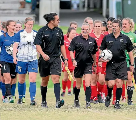  ?? DAVID JOSEPH ?? Referee Wendy McNeely and her assistants John Schumacher and Steve Dowsett lead the players onto the field.