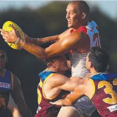  ?? Picture: GETTY ?? Sydney’s Sam Reid looks to handball as he is tackled by Brisbane defenders in their JLT Community Series match