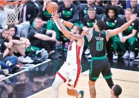  ?? AP PHOTO ?? Boston Celtics forward Jayson Tatum (0) defends Miami Heat forward Caleb Martin (16) during the first half of Game 3 of the NBA basketball playoffs Eastern Conference finals, Sunday, May 21, 2023, in Miami.