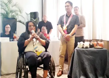  ??  ?? Arnold Agustin, the commission­er of the Philippine Sports Commission, turns over the sports equipment to Ma. Liza Corpuz, head of Persons with Disability Affairs Office, on Thursday, November 8, in Seda Centrio Hotel, Cagayan de Oro City.