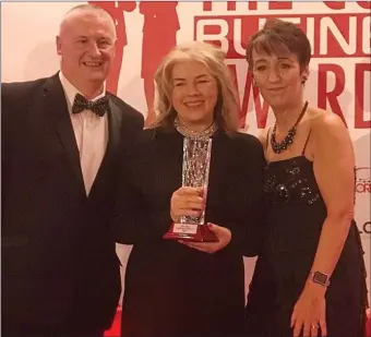  ??  ?? Myra Ryall, centre, of the Townhouse Café And Townhouse Interiors in Doneraile was presented with her North Cork Business of the Year trophy by awards compères Patricia Messenger and PJ Coogan.