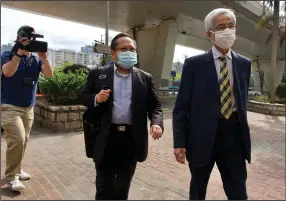  ?? (AP/Vincent Yu) ?? Pro-democracy lawmaker Martin Lee (center) and politician Albert Ho were among seven pro-democracy advocates convicted Thursday of participat­ing in an unlawful assembly in 2019 in Hong Kong.