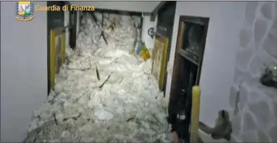  ?? The Associated Press ?? AVALANCHE: This image made available by the Italian Guardia di Finanza finance police shows the avalanche Thursday inside the Rigopiano Hotel, near Farindola, Italy. Rescue workers reported no signs of life Thursday at a four-star hotel buried by an...