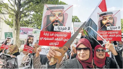  ?? Picture: AFP / FETHI BELAID ?? ANGRY: Women hold up saws and signs showing pictures of Saudi Crown Prince Mohammed bin Salman, at an anti-Saudi Crown Prince protest in Tunis.