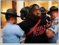  ?? AP/JOHN BAZEMORE ?? Georgia state troopers arrest a man Tuesday in the state Capitol in Atlanta during a protest over election ballot counts.