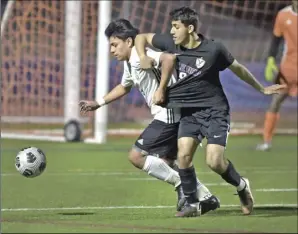  ?? Dan Watson/ The Signal ?? Canyon defender Gilberto Roque (19) and Valencia senior Nadeem Maround (9) wrestle for the ball during Tuesday’s Foothill League matchup at Valencia High School.