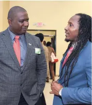  ??  ?? State Minister in the Ministry of Culture, Gender, Entertainm­ent and Sport Alando Terrelonge (right) converses with Scientific Research Council Executive Director Dr Cliff Riley following the opening ceremony for the University of Technology’s (UTech)...