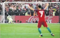  ?? PHOTO/AP ?? WATCHING ON: Cristiano Ronaldo celebrates as Ricardo Quaresma scores the winning penalty against Poland.