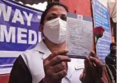  ?? — ASIAN AGE ?? A medical staff poses with a rose outside LNJP Hospital in New Delhi on Saturday.