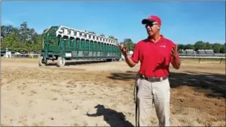  ??  ?? Assistant starter Gus Rodriquez explains how young horses are taught to use the starting gate.