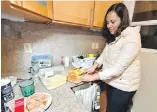  ?? TNS ?? Julieta Zarza Delaluz, a teacher visiting from Mexico, makes an apple salad at her apartment rented at below-market rates in Oakland, California.