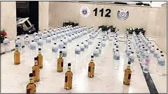  ?? MoI photo ?? Bottles of imported and home-made liquor seized by the police.