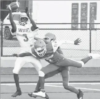  ?? Fred Conley • Times-Herald ?? Two Forrest City Junior Mustang defenders disrupt a West Memphis West passing attempt in the corner of the end zone in first half action during Thursday's junior high game played at Sam Smith Stadium. Forrest City won the game 22-20.