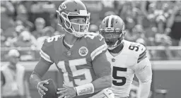  ?? JAY BIGGERSTAF­F/USA TODAY SPORTS ?? Chiefs quarterbac­k Patrick Mahomes throws a pass with Browns defensive end Myles Garrett in pursuit Sunday in Kansas City, Mo.