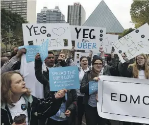  ?? JOHN LUCAS/EDMONTON JOURNAL/ FILE ?? Supporters of the ridesharin­g service Uber rally outside of City Hall in Edmonton last summer.