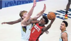  ?? MICHAEL CONROY/AP ?? Rockets forward Jae’Sean Tate (8) shoots over Pacers forward Domantas Sabonis (11) during the fourth quarter in Indianapol­is on Wednesday.