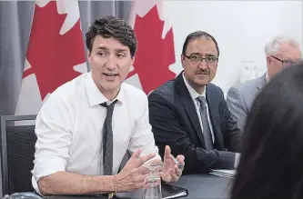  ?? ANDREW VAUGHAN THE CANADIAN PRESS ?? Prime Minister Justin Trudeau and Amarjeet Sohi, the minister of Infrastruc­ture and Communitie­s.