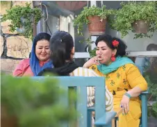  ??  ?? Haidari (right) smokes a cigarette while chatting with her friends at her café where she employs recovered addicts, in Kabul.