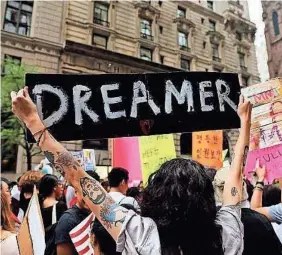  ?? SPENCER PLATT/GETTY IMAGES ?? Dozens of immigratio­n advocates gather for a demonstrat­ion outside Trump Tower last year in New York City.