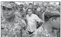  ?? AP/MOHAMED SHARUHAAN ?? Maldivian President Yameen Abdul Gayoom (center), surrounded by his bodyguards, arrives at a rally of supporters Saturday in the nation’s capital, Male.