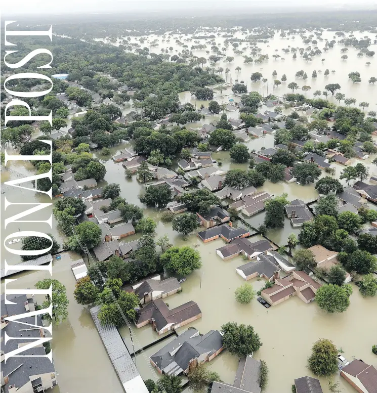  ?? DAVID J. PHILLIP / THE ASSOCIATED PRESS ?? Water from Addicks Reservoir flows into Houston neighbourh­oods on Tuesday as the effects of Hurricane Harvey continue to pound Texas.