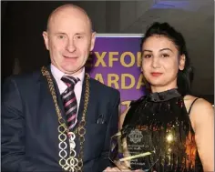  ??  ?? Daiana Salia Fustiac, Enniscorth­y, is presented with her award by Mayor of Wexford, Frank Staples.