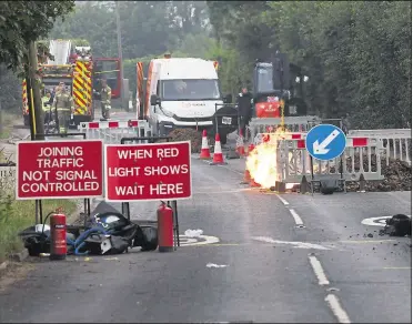  ?? Pictures: Alan Smith/ ?? Southern Gas Network workers at the scene of a gas main fire in Maidstone Road, Sutton Valence