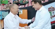  ?? Backpagepi­x ?? COACHES Eddie Jones and Rassie Erasmus (below) exchange handshakes before kick-off of an England vs South Africa encounter. |