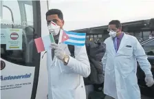  ??  ?? Medics and paramedics from Cuba arrive at the Malpensa airport in Milan last month. A total of 52 Cuban health care workers were sent to help with the pandemic response in Crema, a city in the Lombardy region of north Italy.
