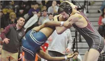  ?? STAFF PHOTO BY CHRIS CHRISTO ?? GETTING A LEG UP: Andrew Piedrahita of Westford Academy (right) gets the better of Ahmad Sharif of Putnam in their 160-pound final during yesterday’s Division 1 state championsh­ips at Newton South High School.