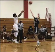  ?? ANDREW ROBINSON/MEDIANEWS GROUP ?? Archbishop Carroll freshman Moses Hipps (left) hoists a shot over La Salle’s Jackson Conroy on Monday night.