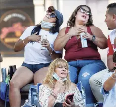  ?? Carol Kaliff / For Hearst Connecticu­t Media ?? Janillex Colon, left, Erica Collazo, right, and Maria Collazo, bottom, swoon to the music of Joe Velez’s Latin Band Saturday on the McLevy Green in Bridgeport in celebratio­n of Spanish Heritage Month.