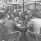  ??  ?? Crowds flock to Eddy’s Bar, part of the Shangri-La resort at Oklahoma’s Grand Lake, as people took advantage of the long Memorial Day weekend. SHANGRI-LA RESORT