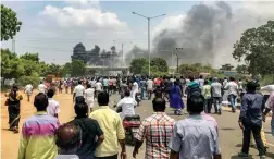  ?? — PTI ?? Smoke rises from burning vehicles after a violent protest demanding closure of Vedanta’s Sterlite Copper unit entered the 100th day in Tuticorin on Tuesday.