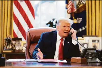  ?? Associated Press ?? In this image released Thursday in the final report by the House select committee investigat­ing the Jan. 6 attack on the U.S. Capitol, President Donald Trump talks on the phone to Vice President Mike Pence from the Oval Office of the White House on the morning of Jan. 6, 2021.