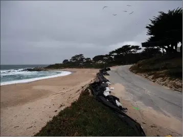  ?? PHOTOS BY TESS KENNY — MONTEREY HERALD ?? High tide associated with the barrage of storms that battered the state from Dec. 27to mid-January undermined a stretch of Scenic Road in Carmel.