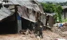  ?? Photograph: Thoko Chikondi/AP ?? A man stands outside his damaged home in Blantyre, Malawi.